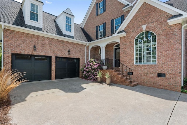 traditional-style home featuring driveway, brick siding, a shingled roof, and crawl space