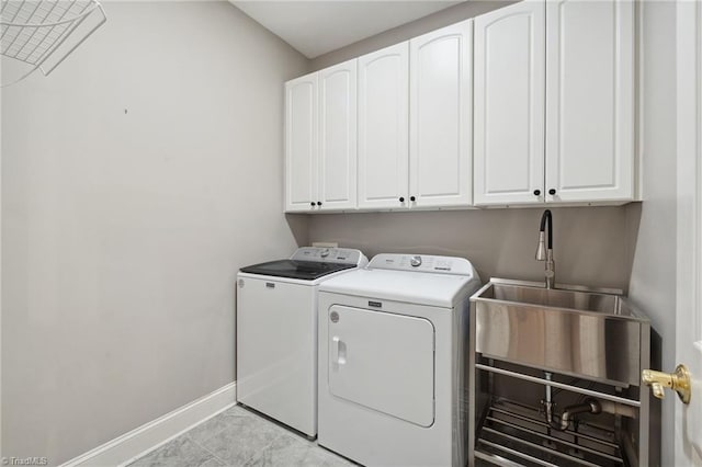 laundry area featuring cabinet space, washer and clothes dryer, and baseboards