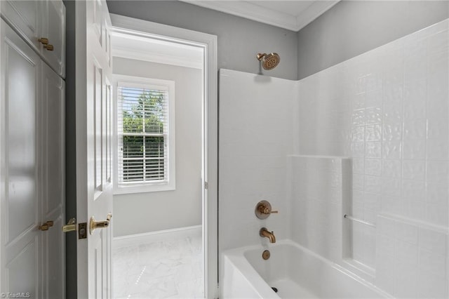 bathroom with crown molding, tub / shower combination, marble finish flooring, and baseboards
