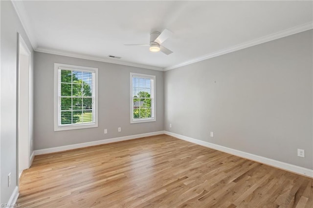 unfurnished room with ornamental molding, light wood finished floors, a ceiling fan, and baseboards