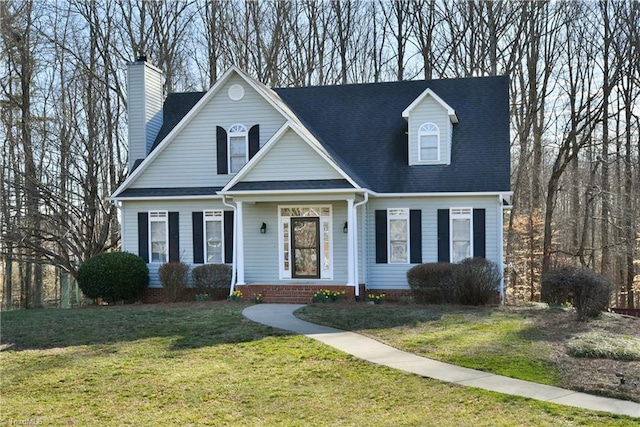 cape cod house featuring a front lawn