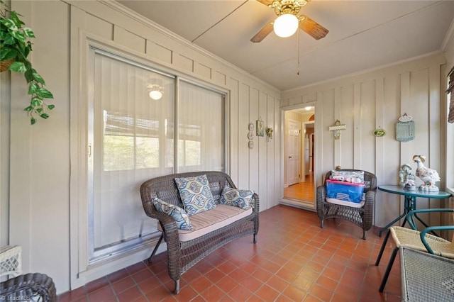 sunroom / solarium featuring a ceiling fan