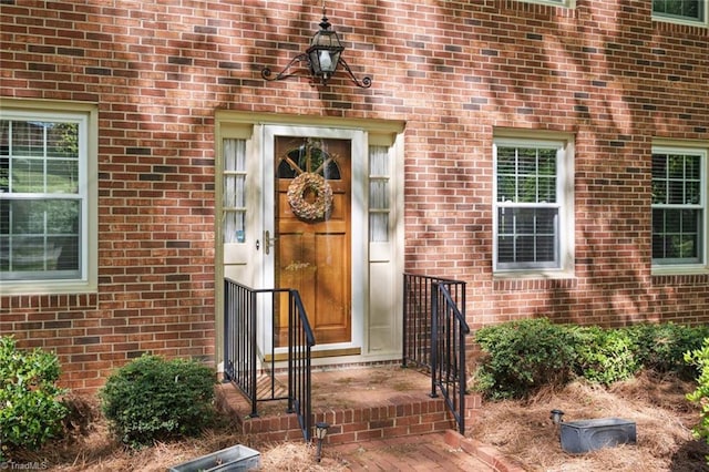 doorway to property with brick siding