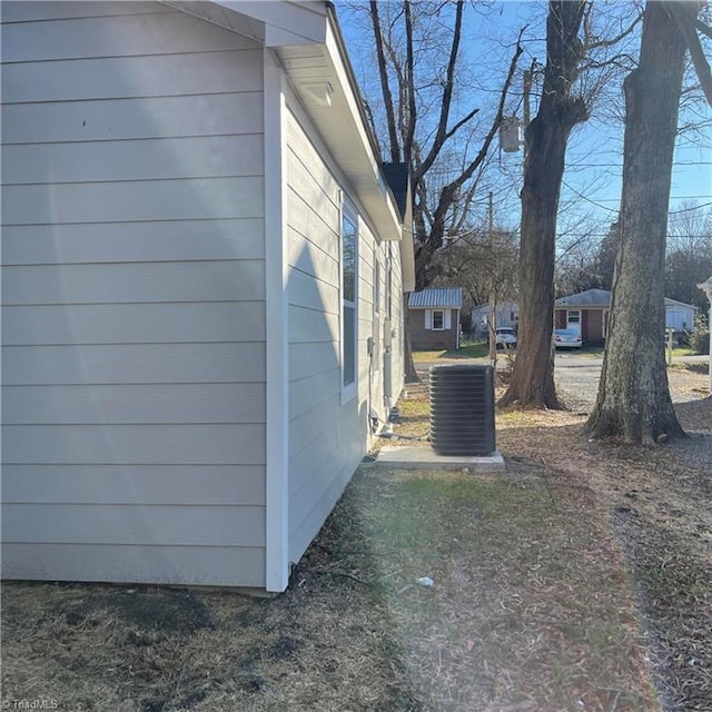 view of side of home featuring cooling unit