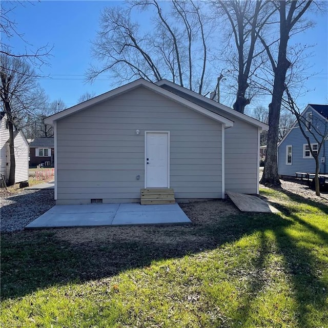 rear view of property with a lawn and a patio