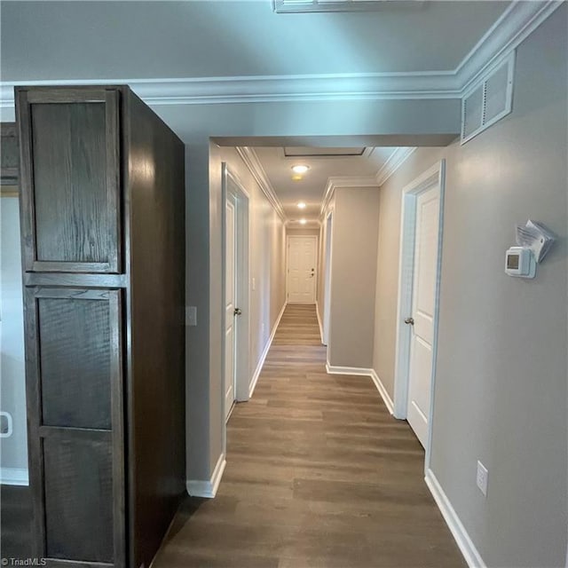 hallway featuring hardwood / wood-style floors and ornamental molding