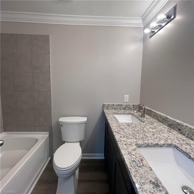 bathroom featuring vanity, toilet, ornamental molding, a tub to relax in, and wood-type flooring