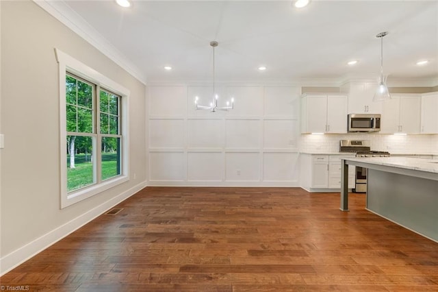 kitchen featuring white cabinetry, hardwood / wood-style floors, and stainless steel appliances