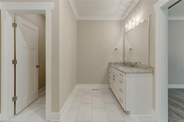 bathroom with ornamental molding and vanity