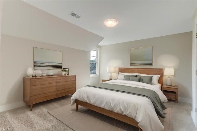 bedroom featuring lofted ceiling and light carpet