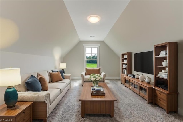 carpeted living room featuring vaulted ceiling