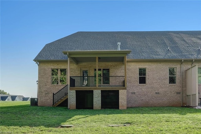 back of house with central AC and a yard