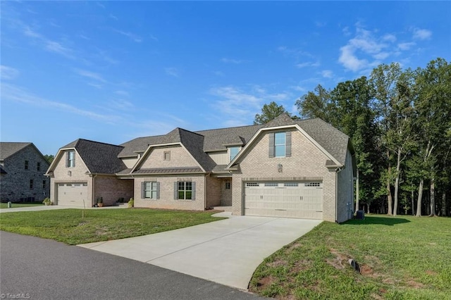 view of front of house with a front yard and a garage