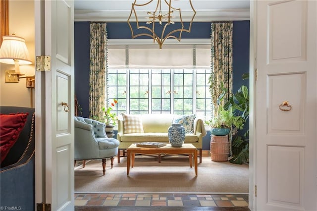 sitting room featuring plenty of natural light, a notable chandelier, and carpet floors