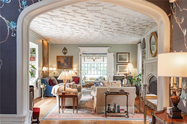 living room with wood-type flooring and crown molding