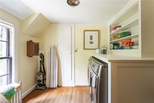 laundry area featuring light hardwood / wood-style flooring and separate washer and dryer