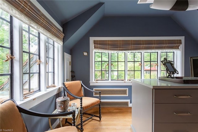 sitting room featuring vaulted ceiling, a healthy amount of sunlight, and light hardwood / wood-style floors