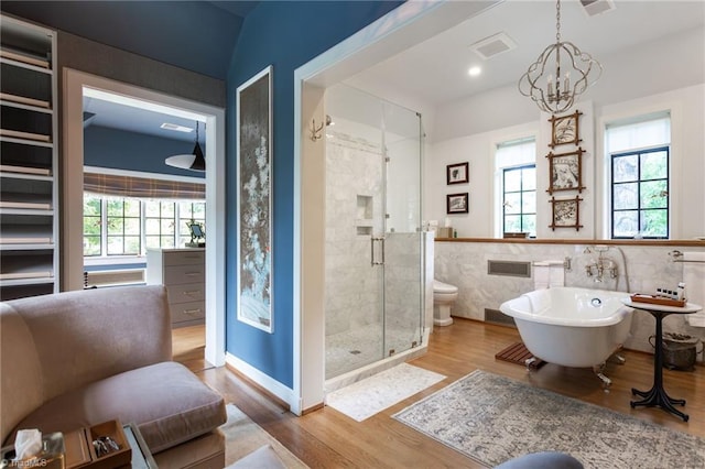 full bathroom featuring vanity, an inviting chandelier, wood-type flooring, tile walls, and independent shower and bath