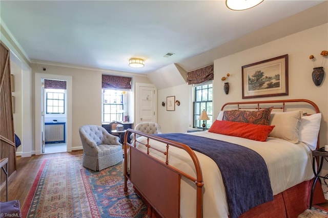 bedroom featuring lofted ceiling and hardwood / wood-style flooring