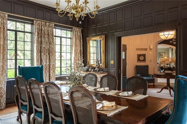 dining area featuring wood-type flooring and a notable chandelier