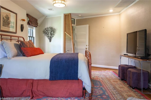 bedroom featuring crown molding and hardwood / wood-style floors