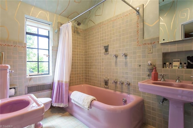 bathroom with tile patterned floors, shower / bath combo, toilet, tile walls, and radiator heating unit