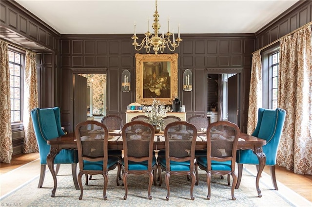 dining space with ornamental molding, a healthy amount of sunlight, and a chandelier