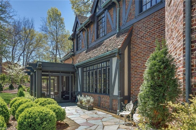 back of house featuring a patio area and a sunroom