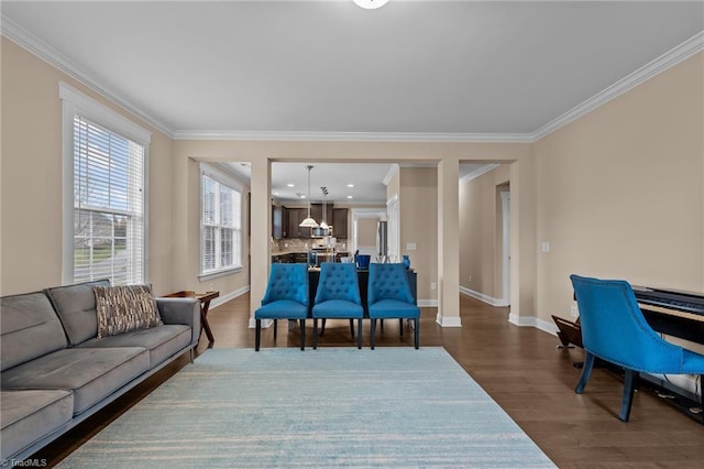 living room featuring dark wood-type flooring and ornamental molding