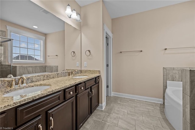 bathroom featuring a tub to relax in and vanity