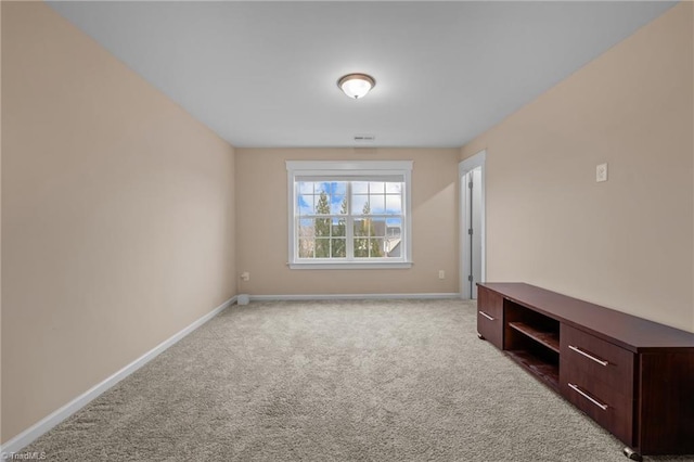 unfurnished room featuring light colored carpet