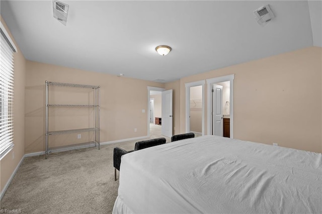 carpeted bedroom with a spacious closet, a closet, and ensuite bathroom