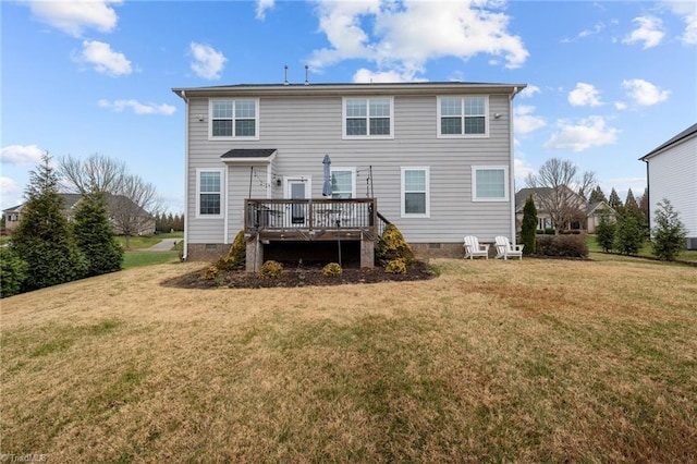 rear view of property featuring a yard and a wooden deck