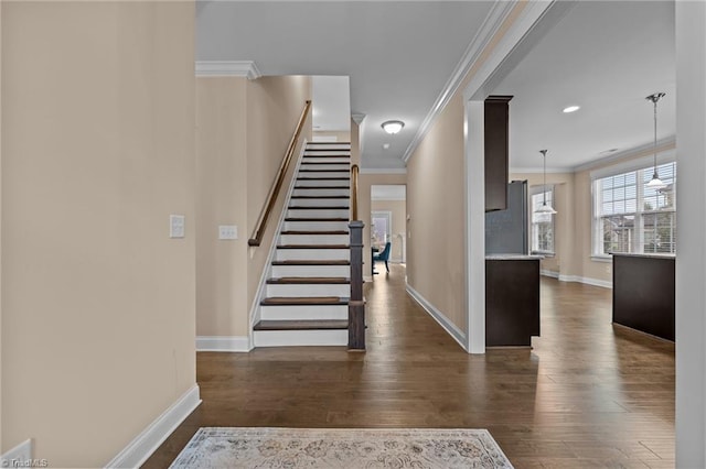 stairway featuring hardwood / wood-style flooring and crown molding