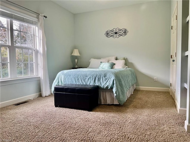 bedroom featuring visible vents, carpet flooring, and baseboards