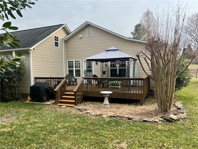 rear view of property with a gazebo, a lawn, and a wooden deck