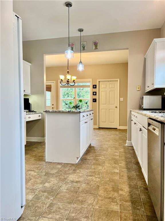 kitchen featuring white cabinets and stainless steel dishwasher