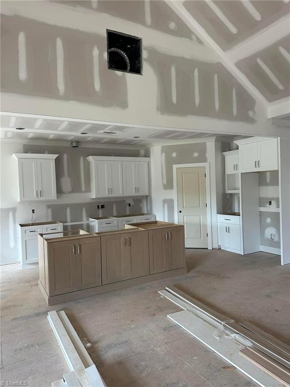 kitchen with a spacious island and white cabinetry