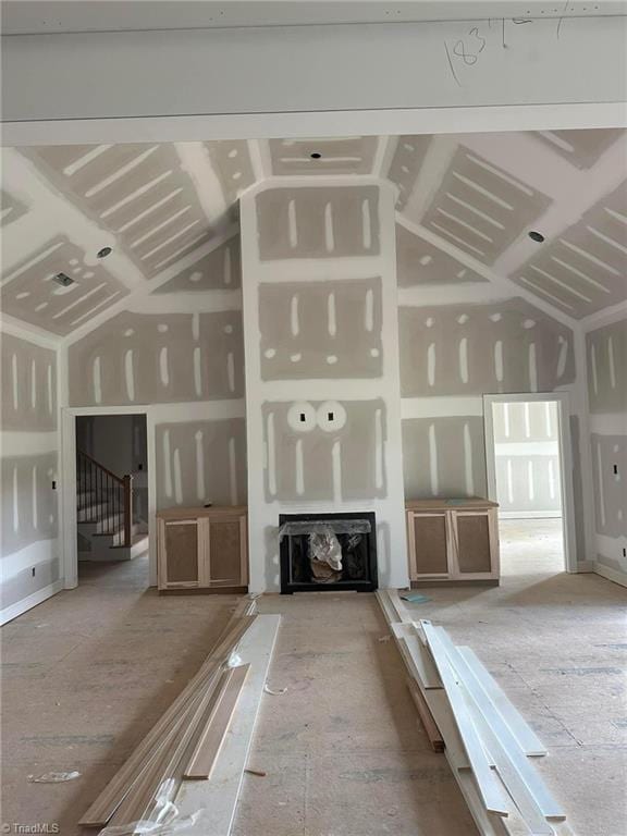 unfurnished living room featuring lofted ceiling and a fireplace