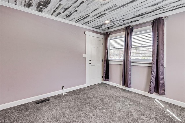 carpeted spare room with wooden ceiling, visible vents, crown molding, and baseboards