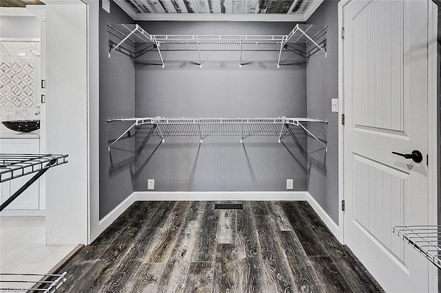 spacious closet featuring visible vents and wood finished floors