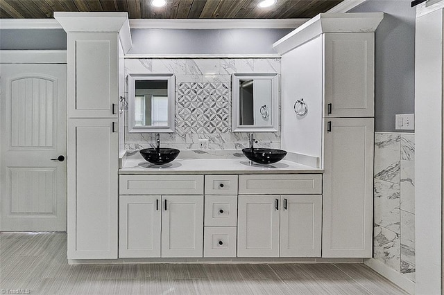 full bathroom with double vanity, wooden ceiling, crown molding, and a sink