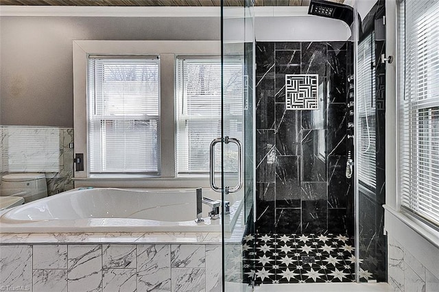 full bath featuring a shower stall, crown molding, and a bath