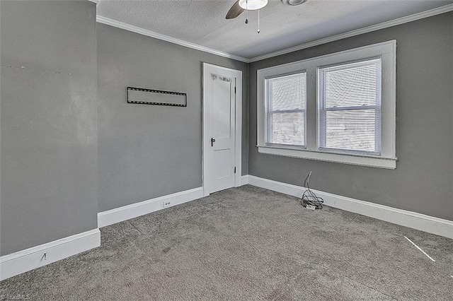 empty room with baseboards, ceiling fan, carpet, a textured ceiling, and crown molding