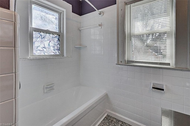 full bathroom featuring washtub / shower combination and tile walls