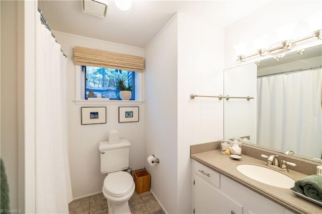 bathroom with toilet, crown molding, tile patterned floors, and vanity