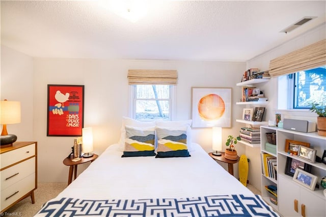 carpeted bedroom featuring a textured ceiling