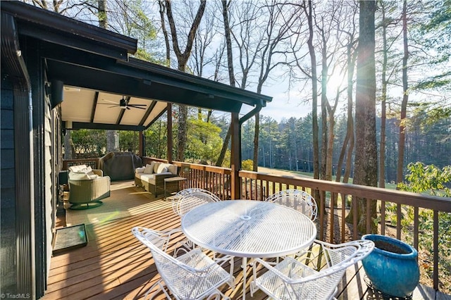 wooden deck with ceiling fan and an outdoor living space