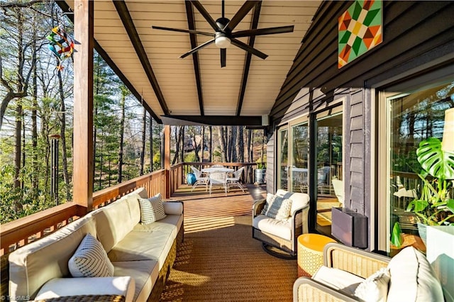 sunroom with lofted ceiling and ceiling fan