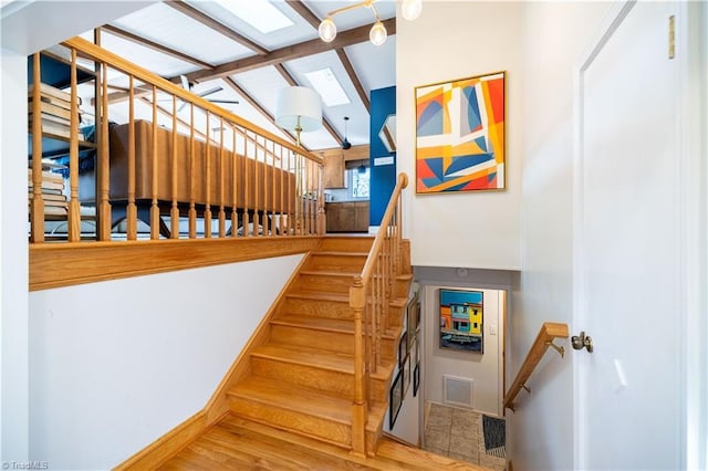 staircase featuring lofted ceiling